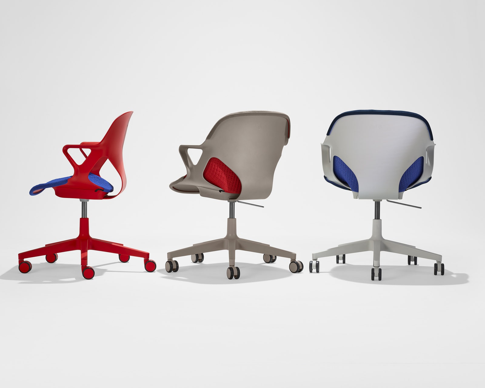Three Herman Miller Zeph office chairs in different colors