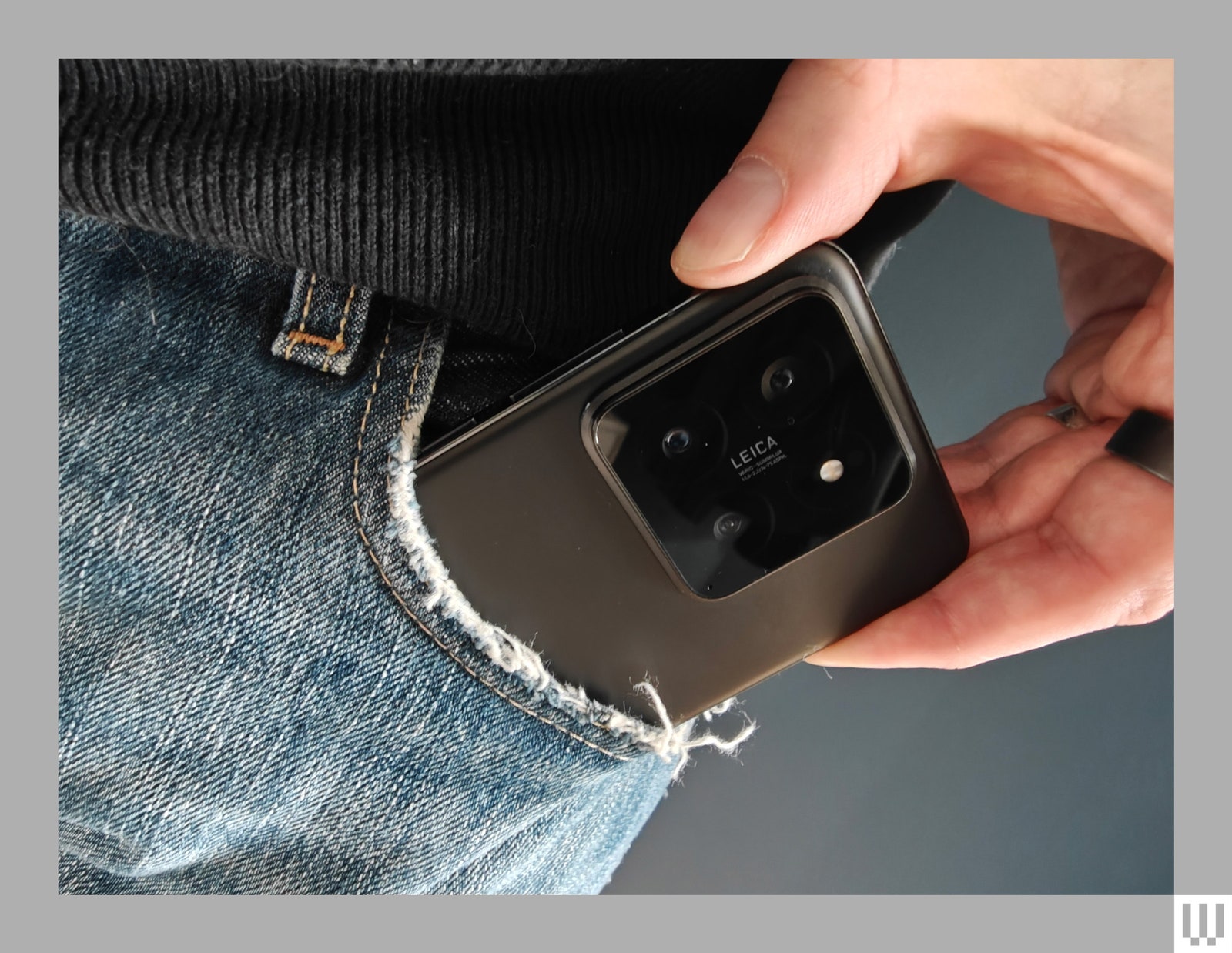 Person pulling the Xiaomi 14 smartphone out of a pants pocket