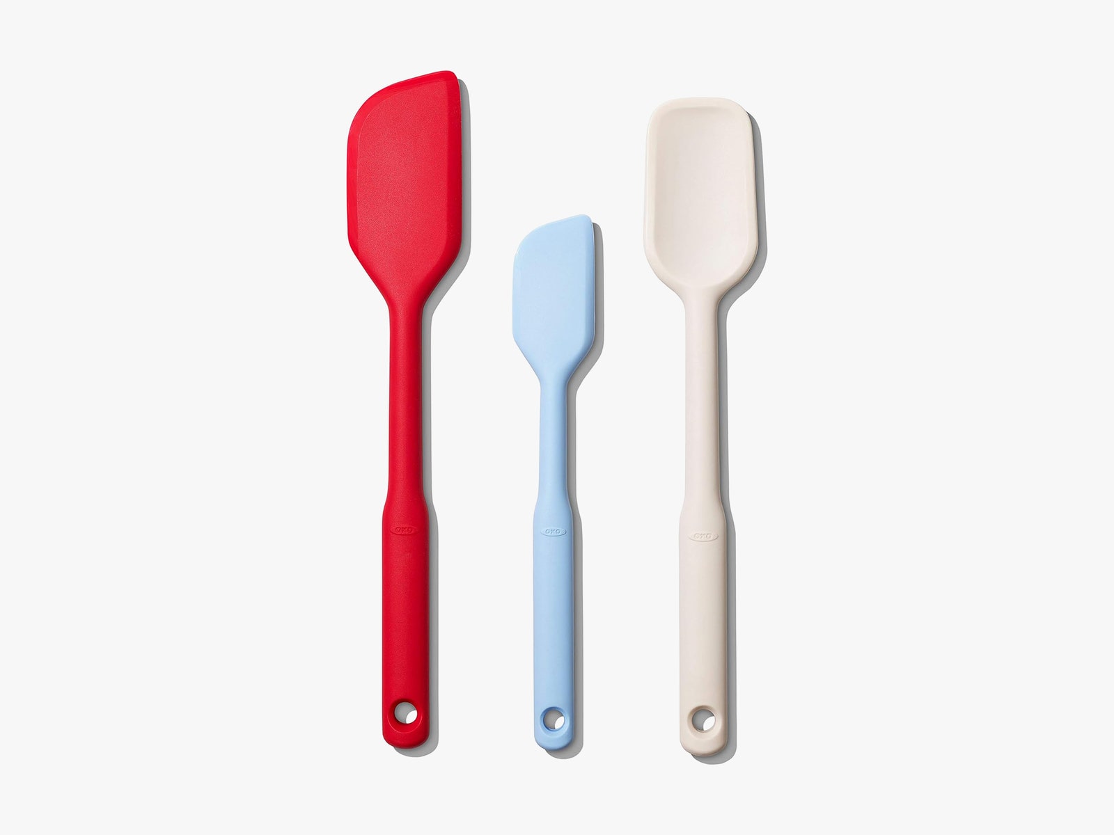 3 silicone spatulas side by side are red blue and white from left to right